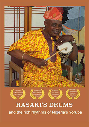 Image for film: Rasaki's Drums and the rich rhythms of 
                    Nigeria's Yorub¶aacute;.  Image is of a man playing a drum in one half of a rectangle, and a group of drums
                    sitting on a floor next to a map of Nigeria in the other half of the rectangle.